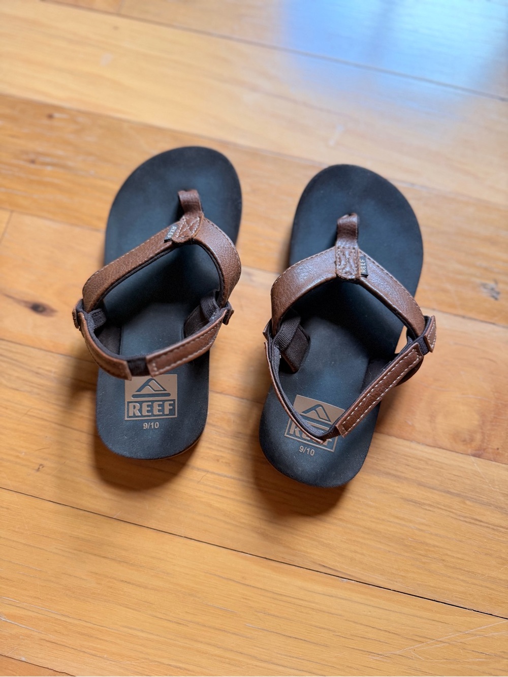 Reef Brown and Black Leather-Strap Flip Sandals.